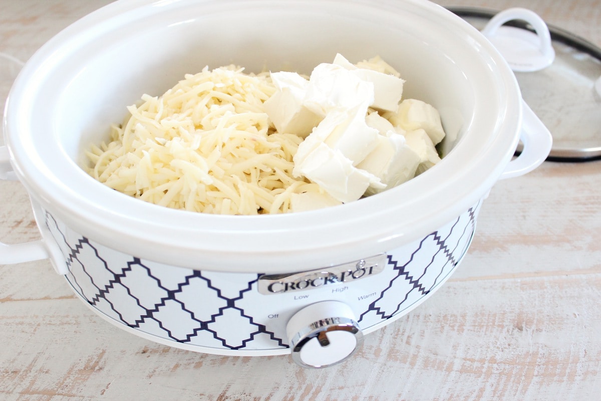 cubed cream cheese and shredded pepper jack cheese in crock pot