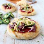 Sriracha pizza sauce, jalapenos, summer sausage and jalapeno cheddar cheese top this delicious mini pizza recipe, perfect for game days and parties!