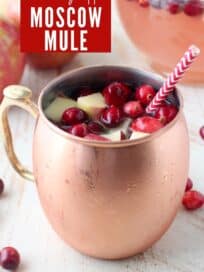 Moscow mule with fresh cranberries and diced apples in copper mug