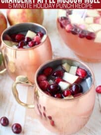 Moscow mule with fresh cranberries and diced apples in copper mugs