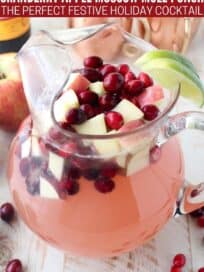 Moscow mule punch with diced apples and cranberries in glass pitcher