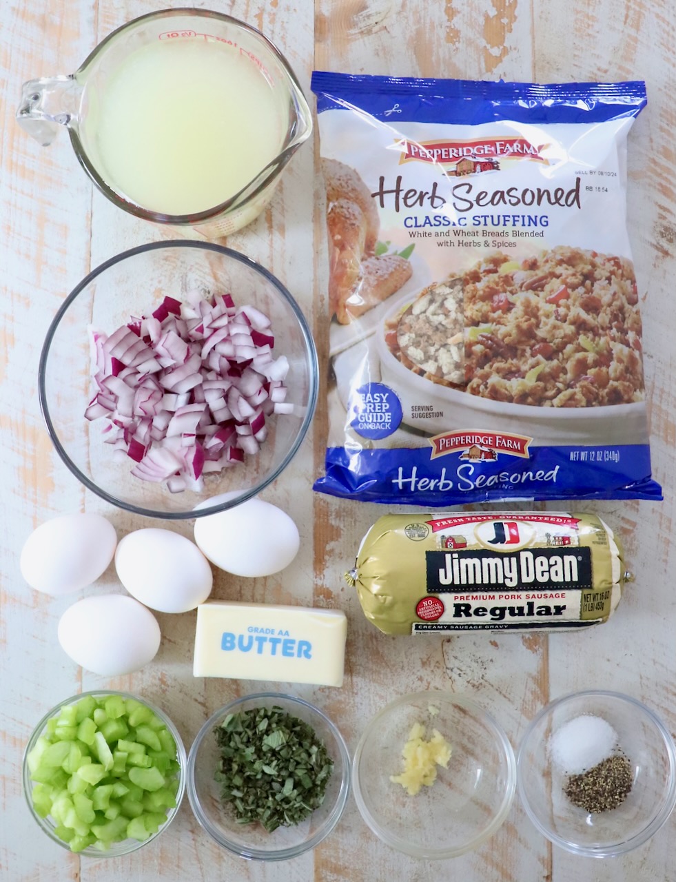 ingredients for sausage stuffing on a white wood board