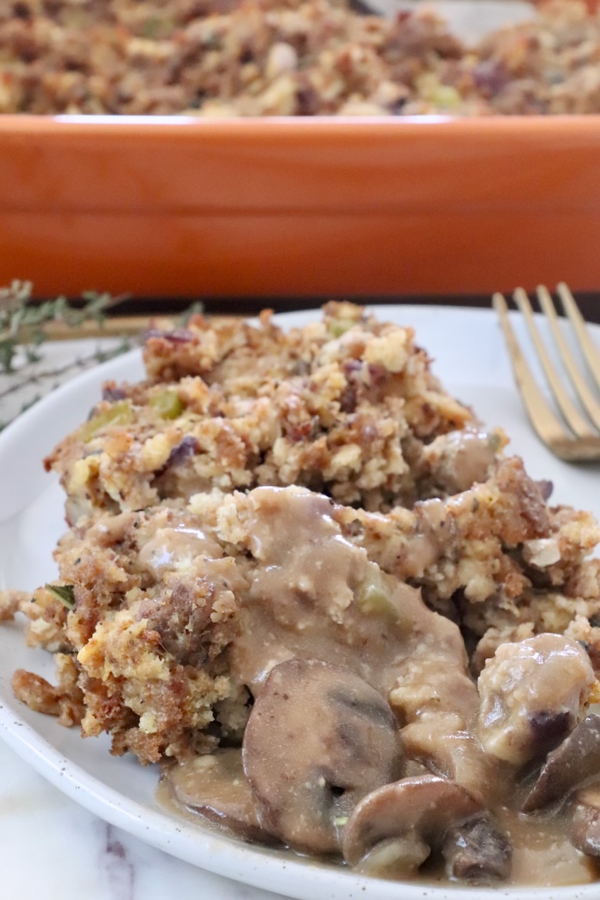 sausage stuffing on a plate topped with mushroom gravy