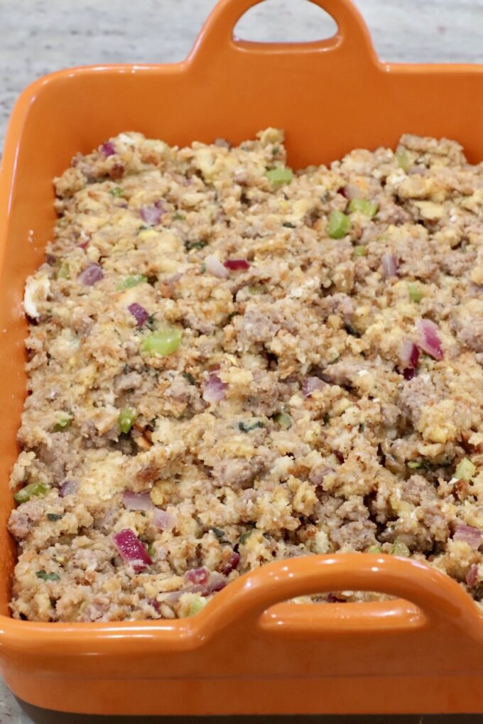 uncooked sausage stuffing in a casserole dish