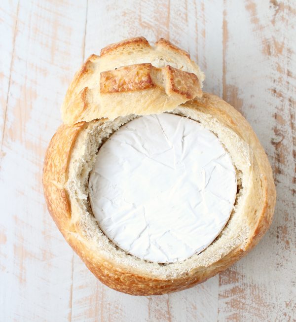 round of brie in the middle of a round of sourdough bread