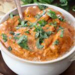cooked butter chicken in bowl with spoon