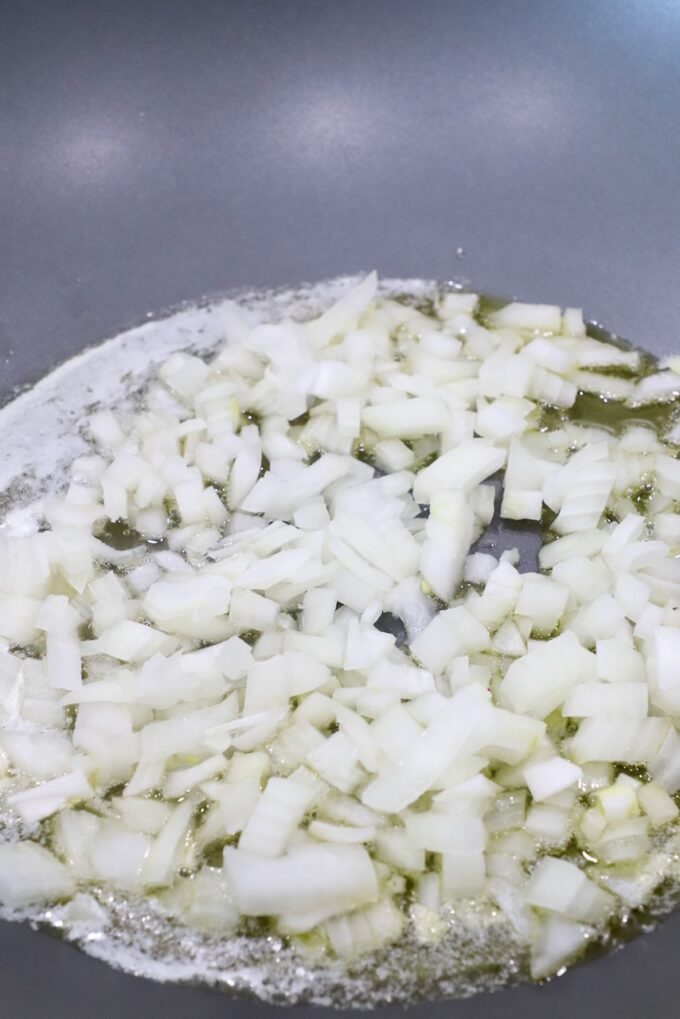 diced onions in melted butter in large skillet