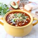 This Slow Cooker Chicken Enchilada Soup recipe is easy to prep in only 10 minutes & given a deliciously spicy kick with the addition of Sriracha!