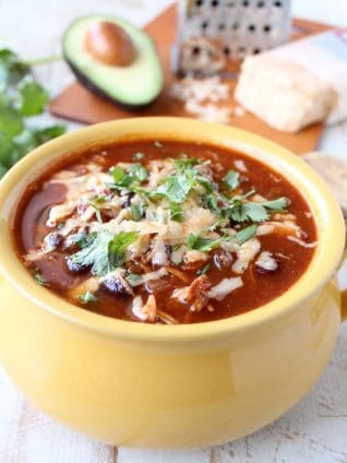 This Slow Cooker Chicken Enchilada Soup recipe is easy to prep in only 10 minutes & given a deliciously spicy kick with the addition of Sriracha!