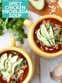 Overhead image of enchilada soup in yellow bowls topped with sliced avocado