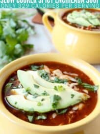 enchilada soup in yellow bowl topped with sliced avocado