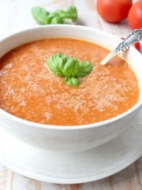 Roasted cherry tomatoes, garlic and onions are pureed into a vegan and gluten free tomato soup recipe, that's so easy to make in only 29 minutes!
