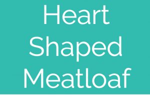 Heart shaped meatloaf on white square plate topped with heart shaped spinach leaves with text overlay "heart shaped meatloaf WhitneyBond.com"