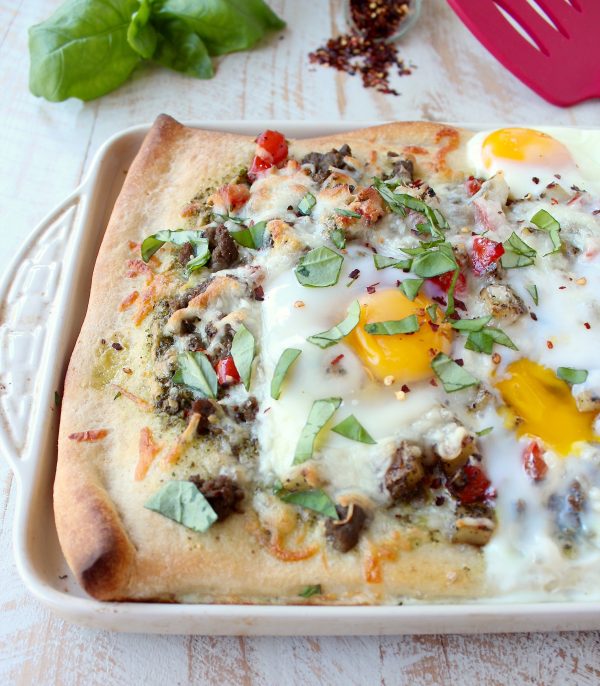 Crispy pizza crust, flavorful turkey sausage, sautéed veggies, baked eggs & parmesan cheese make up this deliciously easy breakfast pizza recipe!