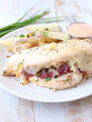 Reuben chicken is tossed with thousand island dressing, stuffed with sauerkraut & corned beef & topped with swiss cheese for a tasty, easy dinner recipe!