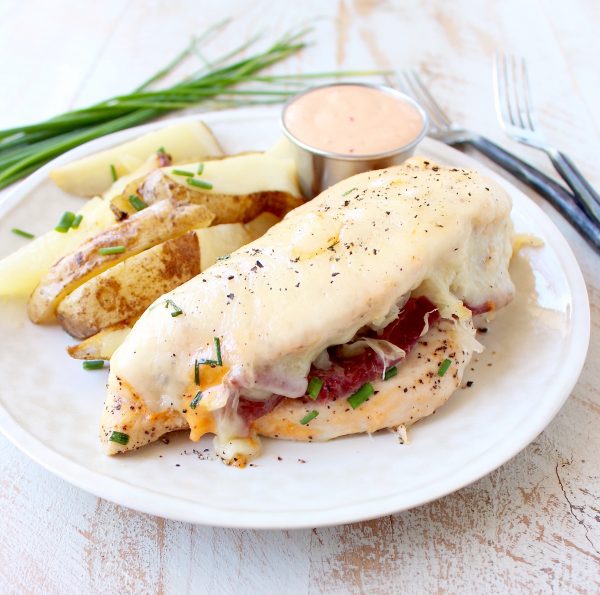 Reuben chicken is tossed with thousand island dressing, stuffed with sauerkraut & corned beef & topped with swiss cheese for a tasty, easy dinner recipe!