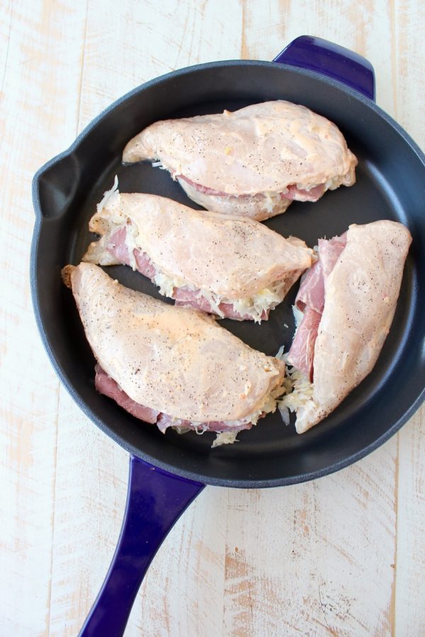 Reuben chicken is tossed with thousand island dressing, stuffed with sauerkraut & corned beef & topped with swiss cheese for a tasty, easy dinner recipe!