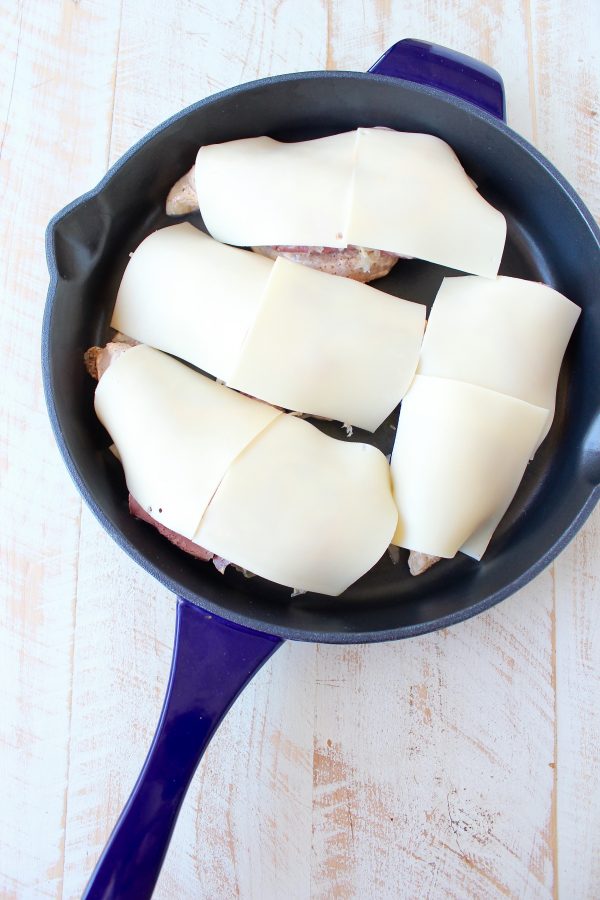 Reuben chicken is tossed with thousand island dressing, stuffed with sauerkraut & corned beef & topped with swiss cheese for a tasty, easy dinner recipe!