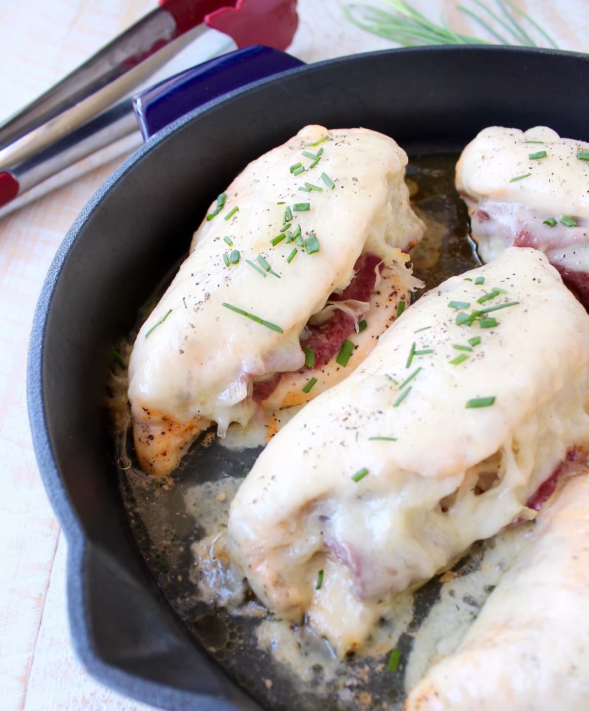Reuben chicken is tossed with thousand island dressing, stuffed with sauerkraut & corned beef & topped with swiss cheese for a tasty, easy dinner recipe!