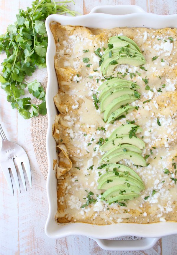 The best vegetarian enchiladas ever combine two cheeses, corn & deliciously creamy avocado sauce for a mouth watering meatless Mexican recipe!