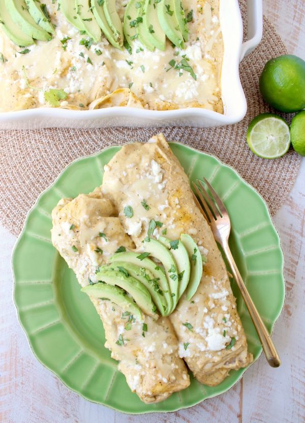 The best vegetarian enchiladas ever combine two cheeses, corn & deliciously creamy avocado sauce for a mouth watering meatless Mexican recipe!