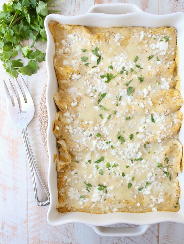 The best vegetarian enchiladas ever combine two cheeses, corn & deliciously creamy avocado sauce for a mouth watering meatless Mexican recipe!