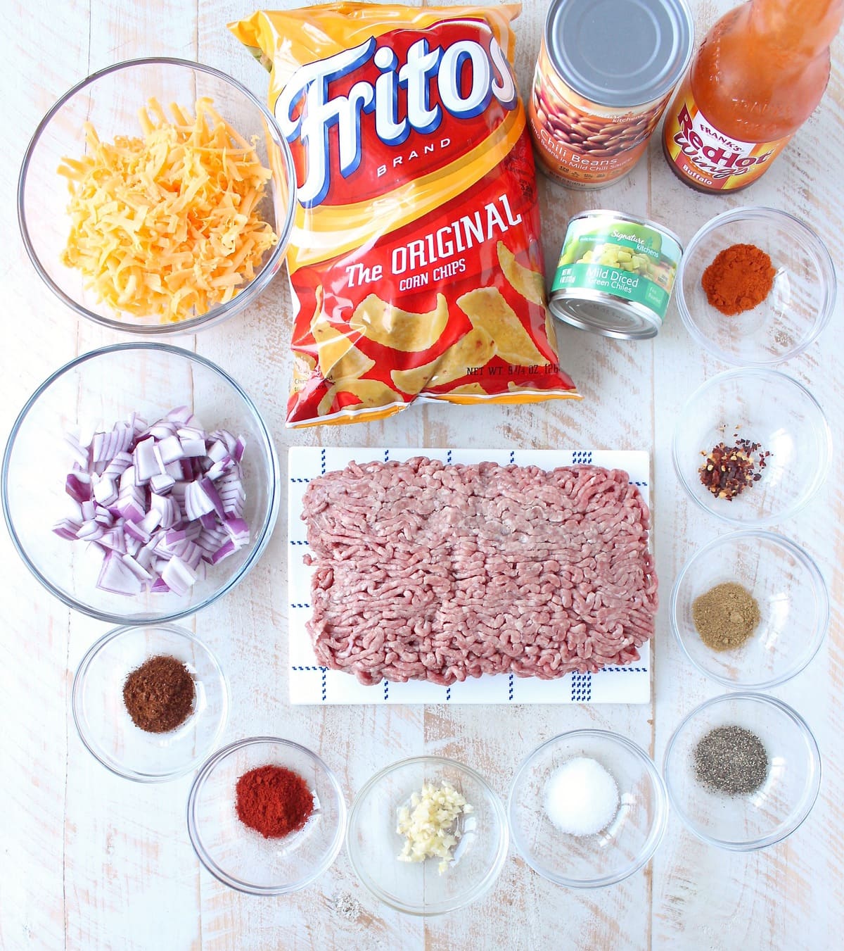 Frito Chili Pie is given a spicy kick with the addition of buffalo sauce, green chilies and spices in this delicious twist on a classic recipe, easy to make in only 20 minutes!