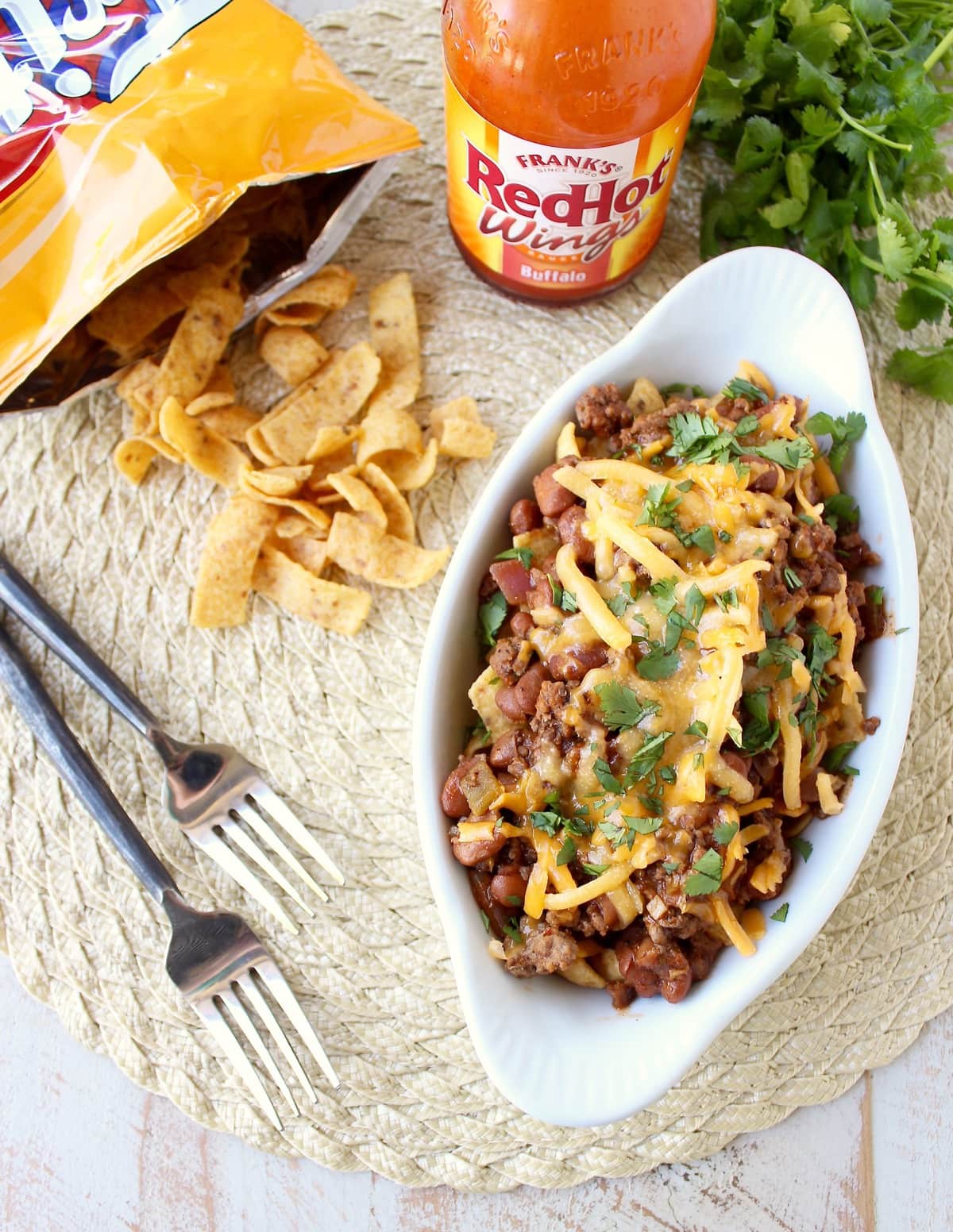 Frito Chili Pie is given a spicy kick with the addition of buffalo sauce, green chilies and spices in this delicious twist on a classic recipe, easy to make in only 20 minutes!