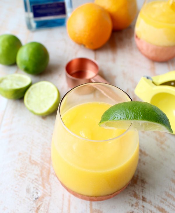 Mango, fresh squeezed orange and lime juice, tequila and triple sec are combined in this deliciously light & refreshing Frozen Mango Margarita Recipe!