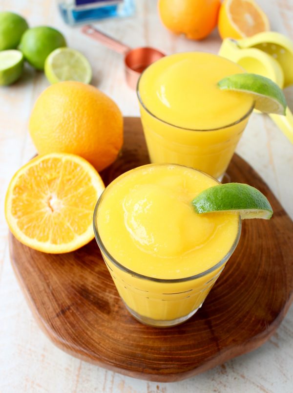 Mango, fresh squeezed orange and lime juice, tequila and triple sec are combined in this deliciously light & refreshing Frozen Mango Margarita Recipe!