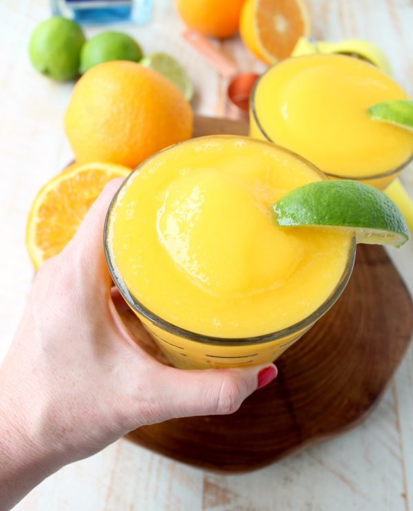 Mango, fresh squeezed orange and lime juice, tequila and triple sec are combined in this deliciously light & refreshing Frozen Mango Margarita Recipe!