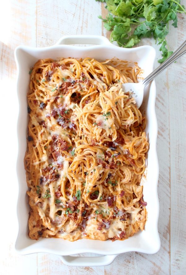 This creamy, dreamy Baked Spaghetti recipe is tossed in a cheesy, bbq sauce with shredded chicken & crispy bacon for a delicious meal made in under an hour!