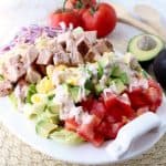 This gluten free Cobb Salad recipe is colorful, flavorful & so easy to make! It's topped with Cajun turkey, avocado, tomatoes & creamy Cajun ranch dressing!