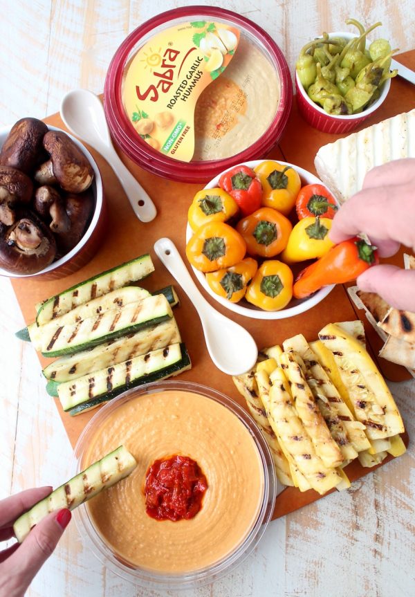 Mediterranean grilled vegetables, pita bread & feta cheese are served with an assortment of flavored hummus on this delicious veggie & hummus plate!