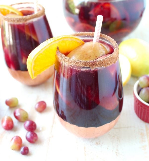 Red Wine Sangria is given a delicious twist in this refreshing cocktail recipe that features cinnamon sugar grilled peaches, apples, oranges and lemons!