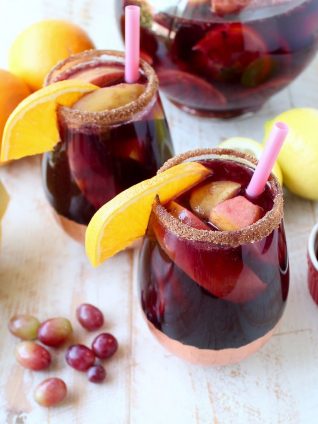 Red Wine Sangria is given a delicious twist in this refreshing cocktail recipe that features cinnamon sugar grilled peaches, apples, oranges and lemons!