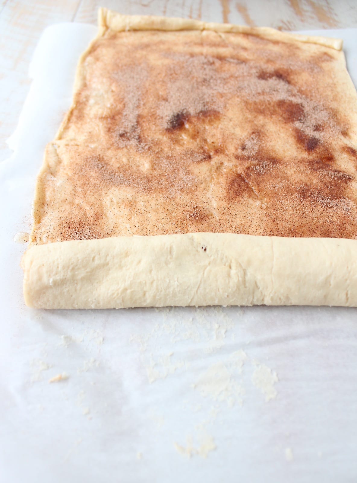 crescent roll dough rolled up over cinnamon and sugar