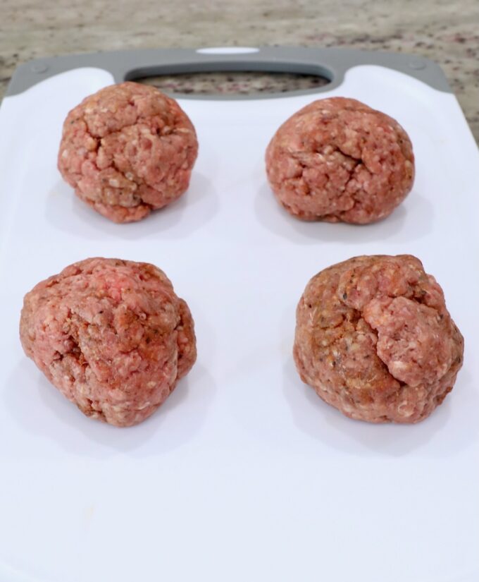 balls of ground beef on cutting board