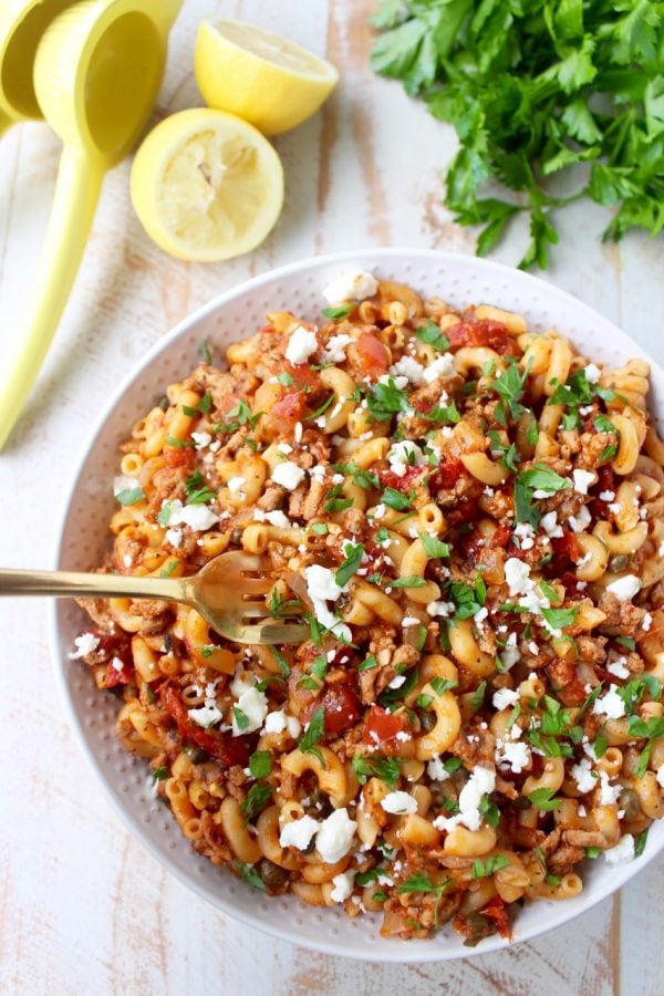 In just one pot and under 45 minutes, make a delicious Greek Pasta recipe filled with sun dried tomatoes, ground turkey, capers and feta cheese!