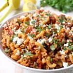 In just one pot and under 45 minutes, make a delicious Greek Pasta recipe filled with sun dried tomatoes, ground turkey, capers and feta cheese!
