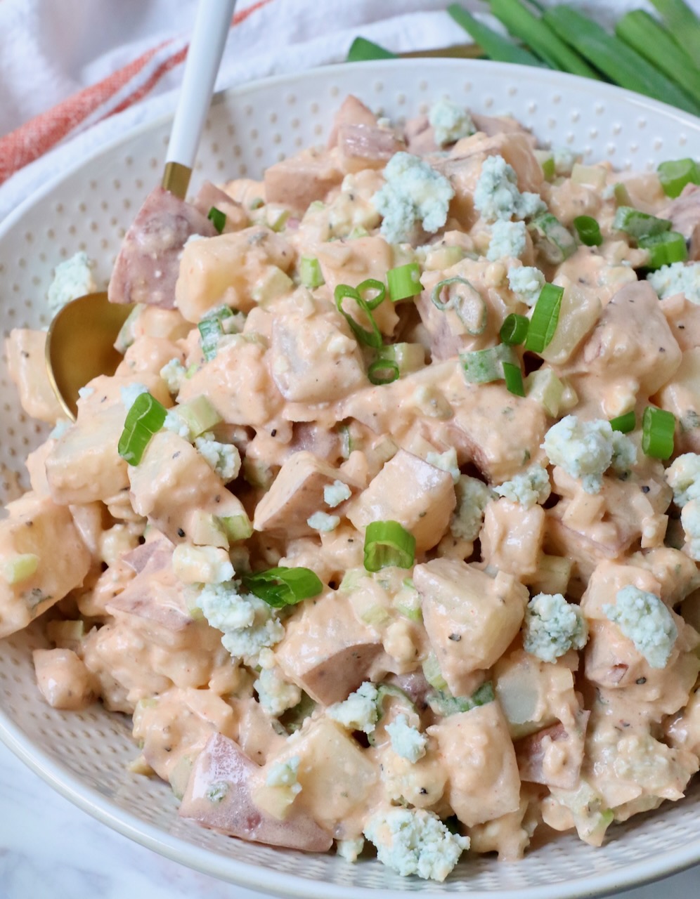 potato salad in bowl with spoon