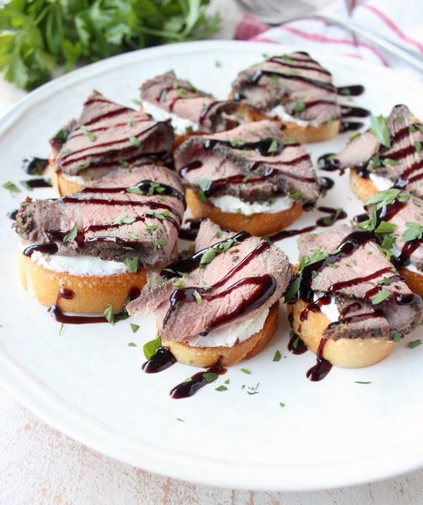 Top sirloin is seasoned & sous vide, then sliced & served atop a crispy baguette with horseradish goat cheese in this delicious steak crostini recipe!