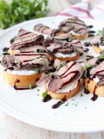 Top sirloin is seasoned & sous vide, then sliced & served atop a crispy baguette with horseradish goat cheese in this delicious steak crostini recipe!