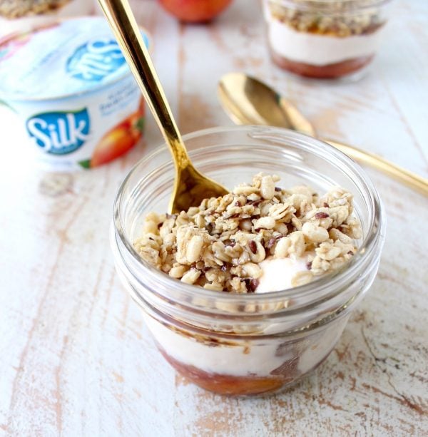 Cinnamon sugar grilled peaches are layered with peach almond milk yogurt and granola in this delicious vegan parfait recipe, great for breakfast or dessert!