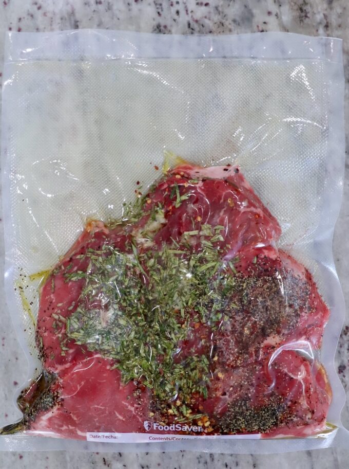 vacuum sealed seasoned steaks in a clear bag