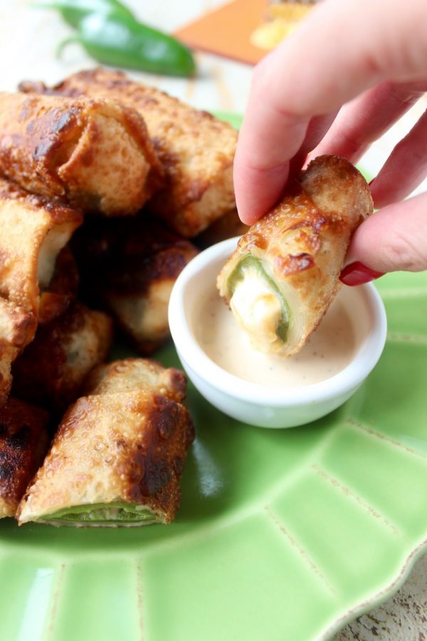 Crispy, cheesy, delicious jalapeno popper egg rolls are the perfect appetizer for parties or game day! They're also so easy to make in under 30 minutes!