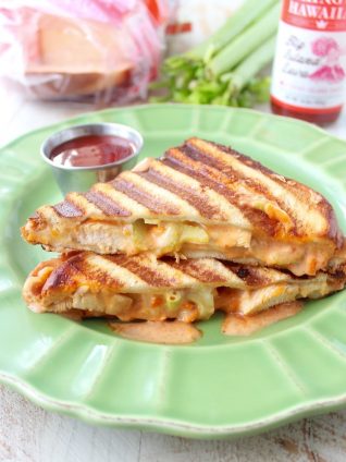 Hot sauce sautéed chicken, pepper jack cheese and a spicy, creamy sauce make up this deliciously saucy and cheesy Spicy Chicken Panini recipe!