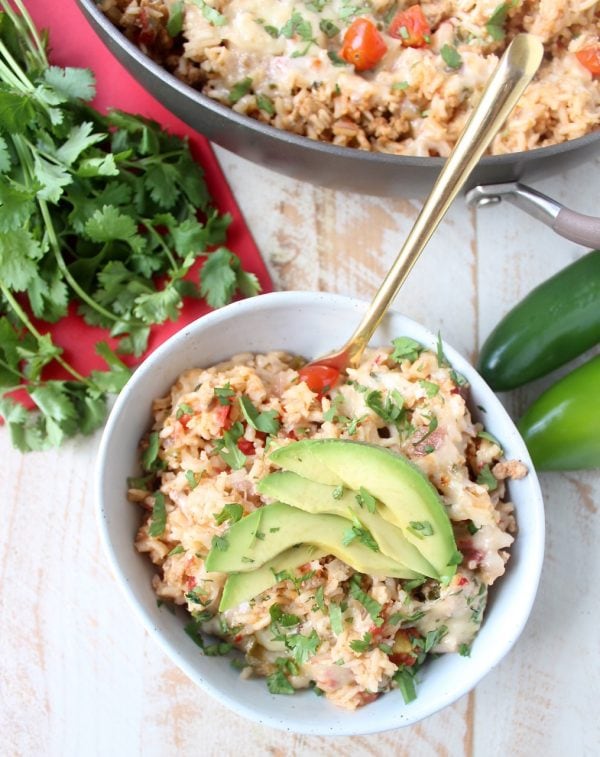 This One Pot Taco Rice Skillet recipe combines ground turkey, rice, veggies, spices & cheese for a quick and easy weeknight dinner that is so delicious!