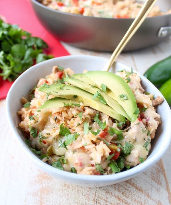 This One Pot Taco Rice Skillet recipe combines ground turkey, rice, veggies, spices & cheese for a quick and easy weeknight dinner that is so delicious!