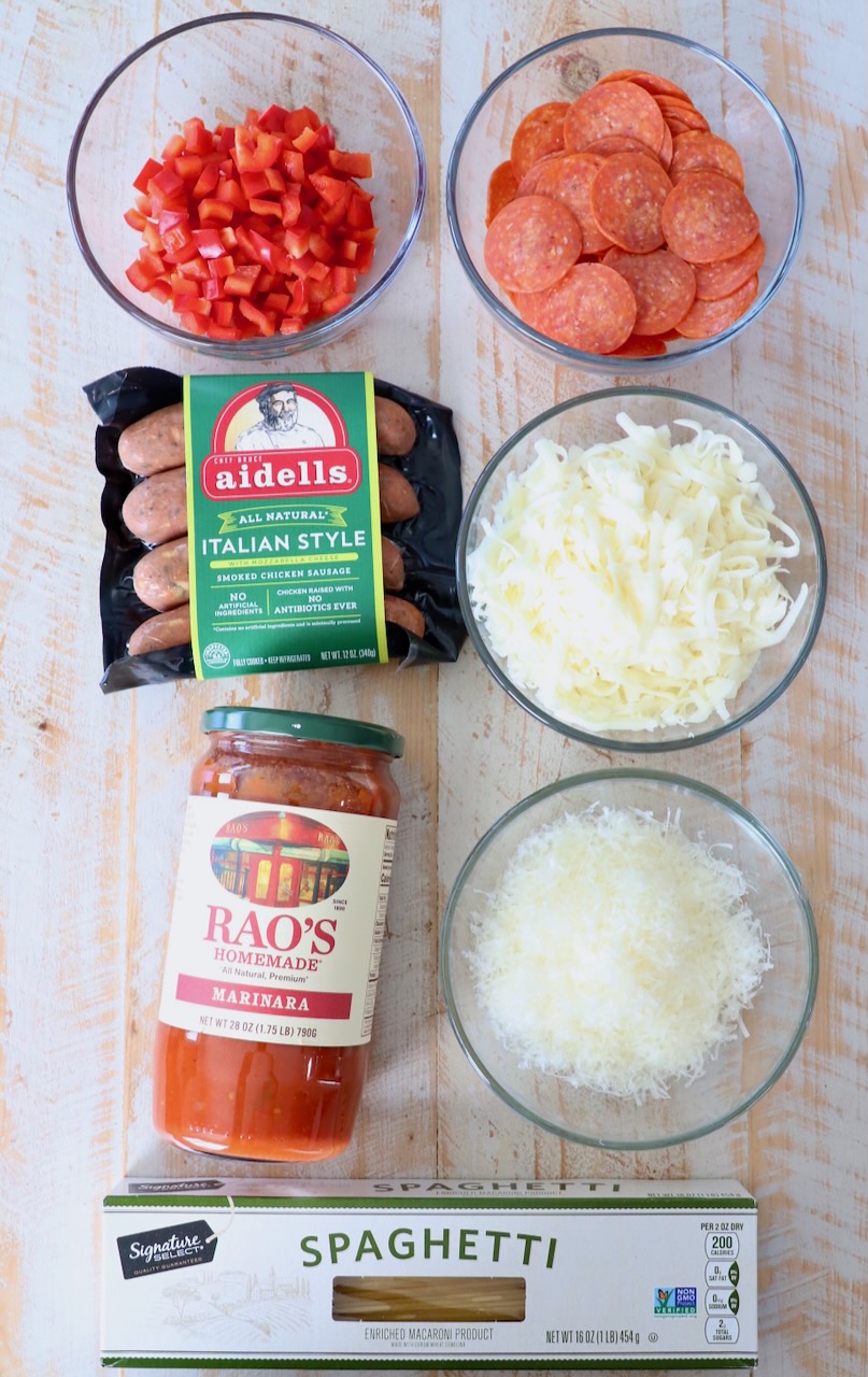 ingredients for pizza baked spaghetti on white wood board